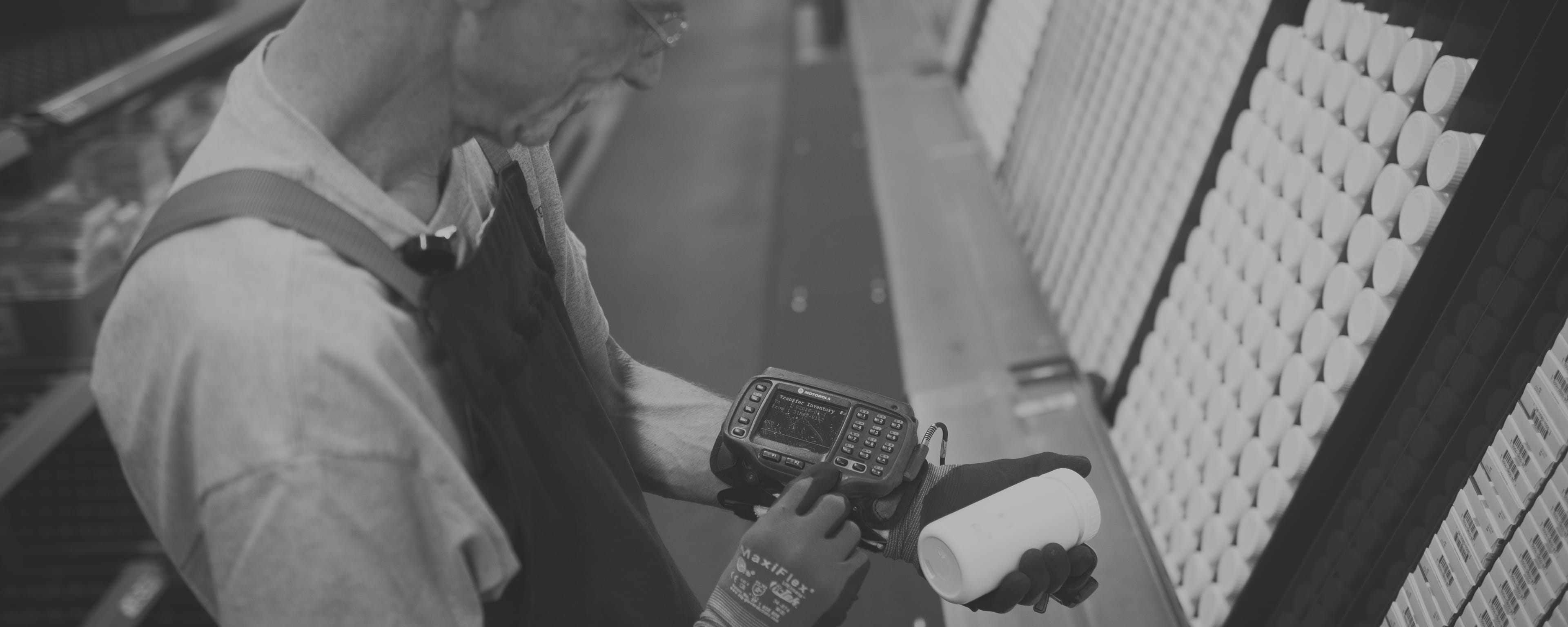 Man with wrist scanner in warehouse