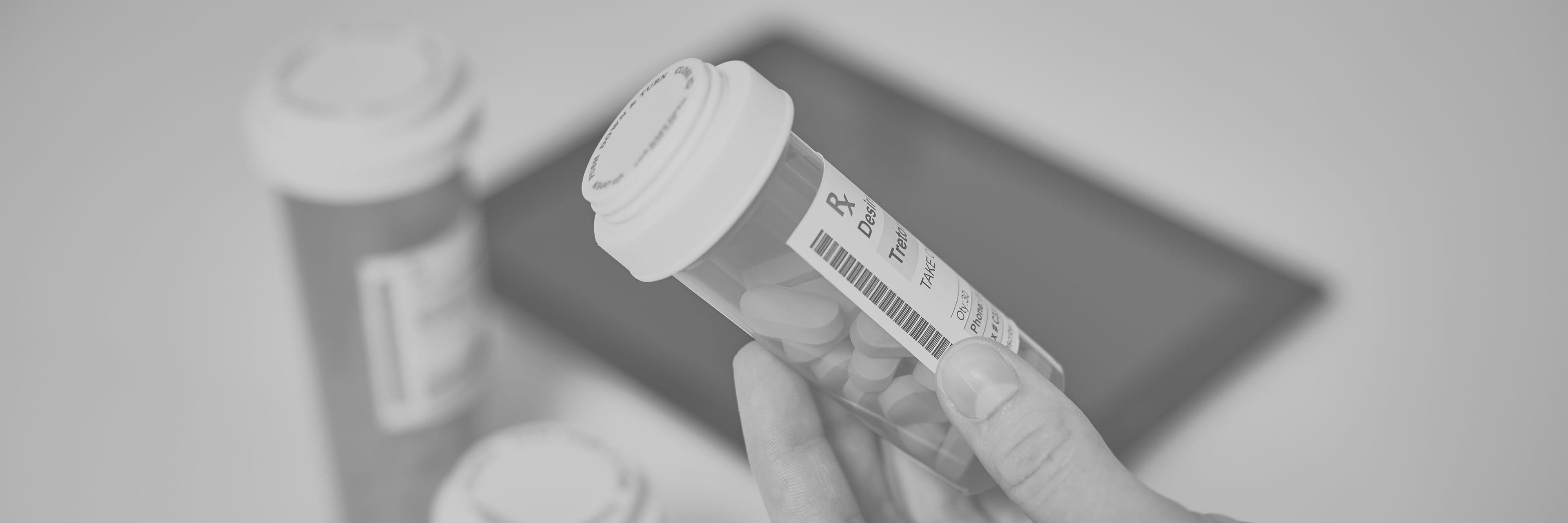 Hand holding a pill container
